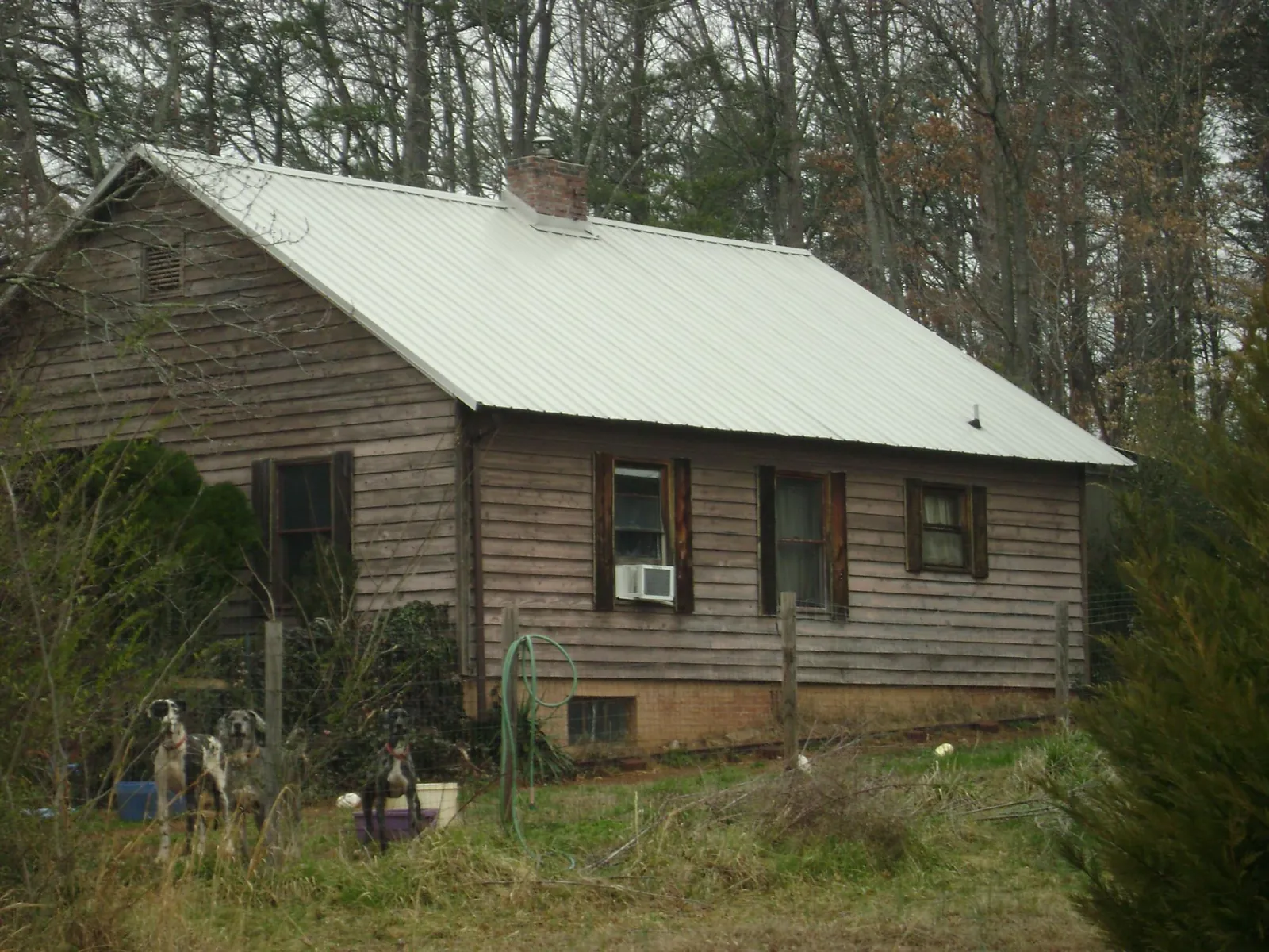 White metal roof on an old wood sided farmhouse, from a Metal Roof Installation job in Watauga
